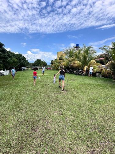 a group of people walking in a field at Finca Hotel Villa el Ocaso Huila in Rivera