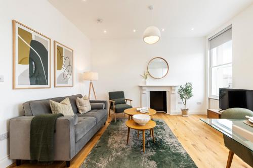 a living room with a couch and a table at The Fulham Residences in London