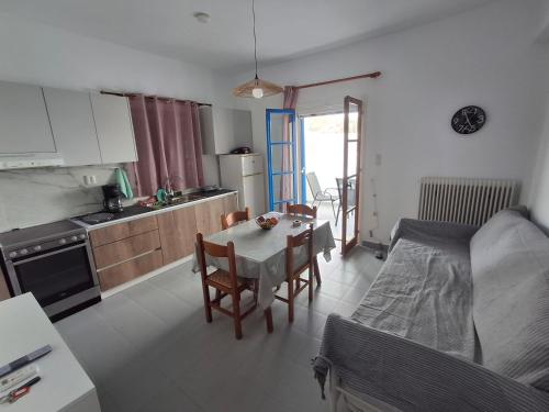 a kitchen with a table and a dining room at Με θέα τον όρμο της Βάρης in Vari