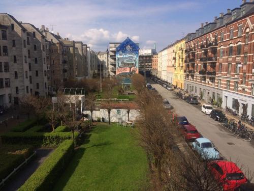 a city with tall buildings and a street with cars at Best location at Vesterbro in Copenhagen