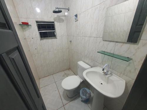 a bathroom with a toilet and a sink at Residencial Romulo Ap 4 in Manaus