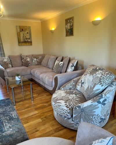 a living room with a couch and two chairs at Lattone House in Belcoo