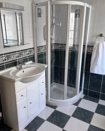 a bathroom with a shower and a sink at Lattone House in Belcoo
