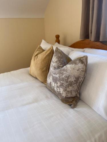 two pillows sitting on top of a bed at Lattone House in Belcoo