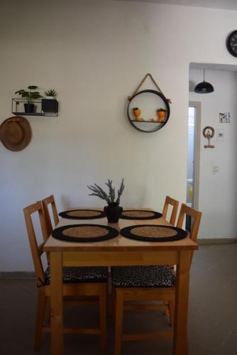 a dining room table with two chairs at Dimitris house in Paralía Avdhíron
