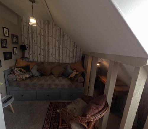 a living room with a couch and a chair at St Elmo Felixstowe in Felixstowe