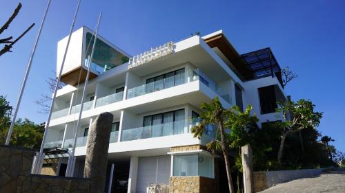 a white building with a lot of windows at Truntum Boutique Mandalika in Kuta Lombok