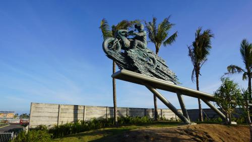 a statue of a person sitting on top of a rail at Truntum Boutique Mandalika in Kuta Lombok