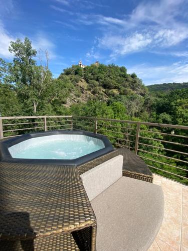 a jacuzzi tub on the balcony of a house at Suite romantique d'Isoarde des Baux - Château de Rochetaillée in Saint-Uze