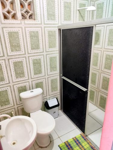 a bathroom with a toilet and a sink and a shower at Pousada Lua e Mar in Belém
