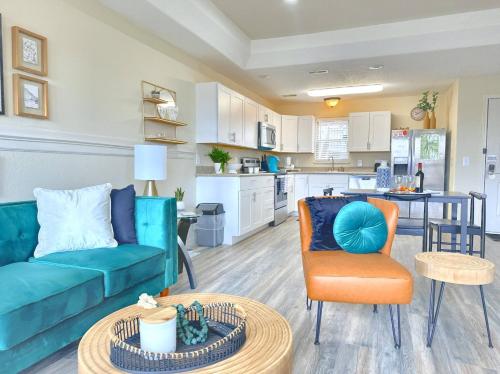 a living room with a couch and a table and a kitchen at Gorgeous Resort, Fish Private Lake, Pools, Golf! in Branson West