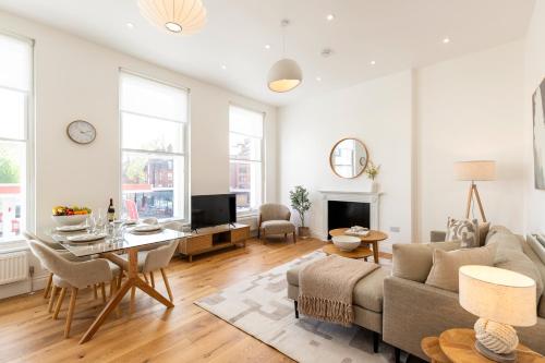 a living room with a couch and a table at The Fulham Residences in London