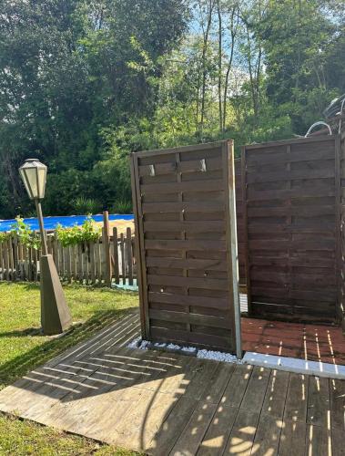 a wooden fence with a gate in a yard at Oasi degli ulivi in Luni