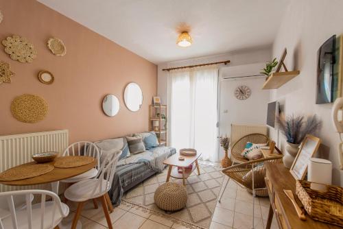 a living room with a couch and a table at Blue Memories in Fanárion