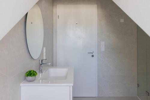 a bathroom with a sink and a mirror at Grand Rue Residence 1 Bedroom Apartment in Luxembourg