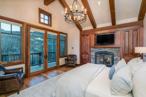 a bedroom with a bed and a fireplace at Two Trails by Exceptional Stays in Telluride