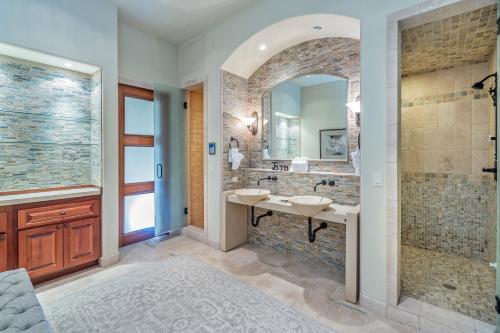 a bathroom with two sinks and a large mirror at Two Trails by Exceptional Stays in Telluride