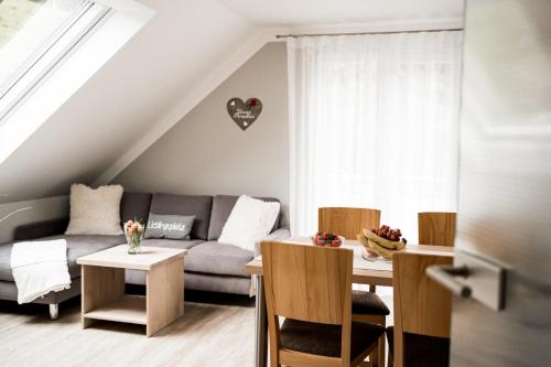 a living room with a couch and a table at Paradies Im Schwarzwald in Bad Peterstal-Griesbach