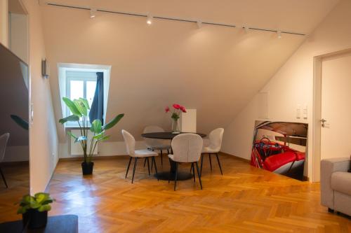 a living room with a table and chairs and a bed at Grand Rue Residence 1 Bedroom Apartment in Luxembourg