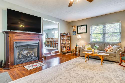 a living room with a fireplace with a flat screen tv at 12 Mi to Indianapolis Motor Speedway Home with Deck in Brownsburg