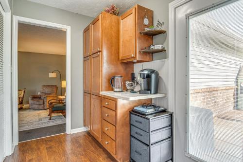 a kitchen with wooden cabinets and a counter top at 12 Mi to Indianapolis Motor Speedway Home with Deck in Brownsburg