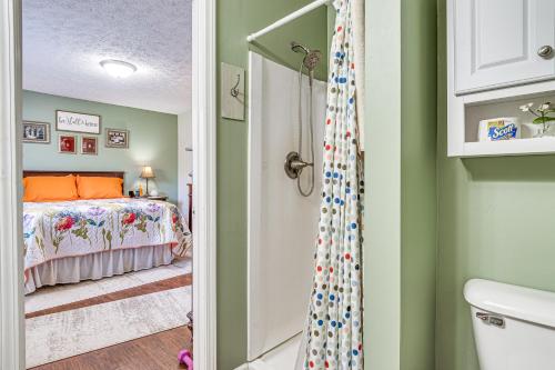 a bedroom with a bed and a shower at 12 Mi to Indianapolis Motor Speedway Home with Deck in Brownsburg
