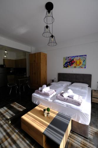 a room with two beds and a table in it at Blue House 1 in Drama