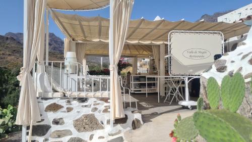 a gazebo with a table and chairs on a patio at Casa Maritina in Mogán