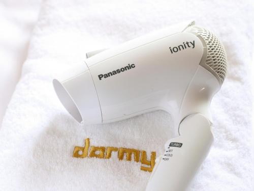 a white hair dryer sitting on top of a towel at Dormy Inn Sapporo Annex in Sapporo