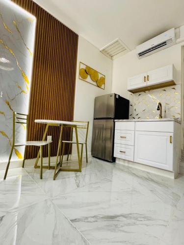 a kitchen with a table and a stainless steel refrigerator at Stylish Studio in Heart of Miami in Miami