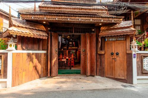 an entrance to a store with a wooden door at Rak Chiang Mai Guesthouse in Chiang Mai