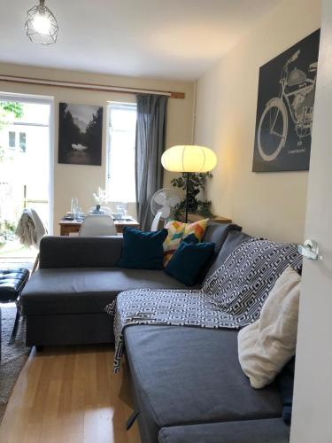 a living room with a couch and a table at Lovely Townhouse with Garden and Parking in Camden Central London in London