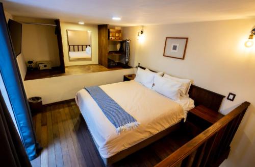 a bedroom with a bed and a large mirror at Hacienda Gobernadores in Mexico City