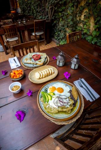a wooden table with plates of food on it at Hacienda Gobernadores in Mexico City
