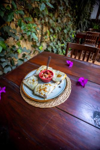 a plate with a bowl of food on a wooden table at Hacienda Gobernadores in Mexico City