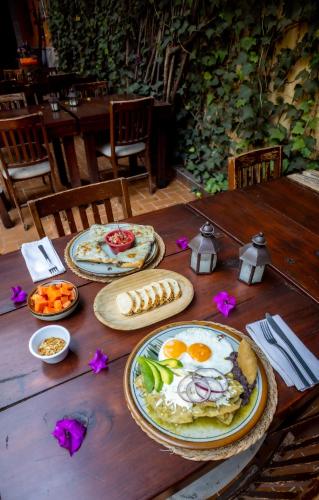 a wooden table with plates of food on it at Hacienda Gobernadores in Mexico City