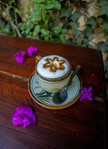 a cup of coffee on a table with a spoon at Hacienda Gobernadores in Mexico City