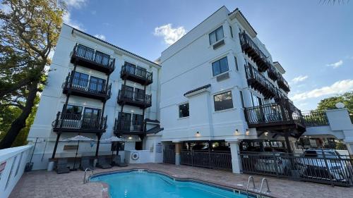 an apartment building with a pool in front of it at Ocean Inn & Suites in Saint Simons Island