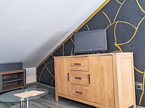 a living room with a tv on top of a dresser at Apartment Siebter Himmel by Interhome in Bad Ischl