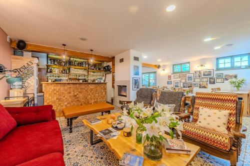 a living room with a couch and a table at Tesla's Gastro House Plitvice in Plitvička Jezera