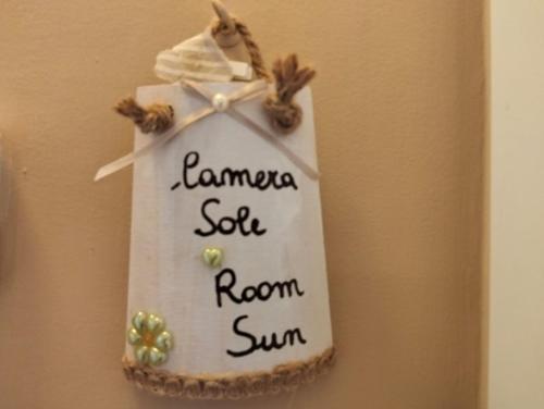 a towel hanging on a wall with the words karma self room sun at Casa della Nonna Pasqua in Taranto