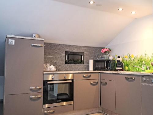 a kitchen with a refrigerator and a microwave at Apartment Siebter Himmel by Interhome in Bad Ischl