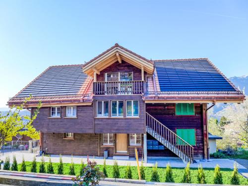 a house with solar panels on the roof at Apartment Huus Chloster- Apt Niesen by Interhome in Krattigen