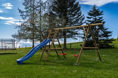 a playground with a blue slide and a slide at Familienapartment Vogtland in Saalig