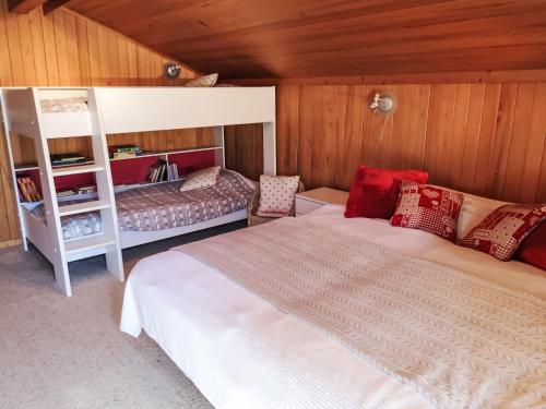 a bedroom with a bed and a bunk bed at Apartment Chalet Tiptop by Interhome in Les Diablerets