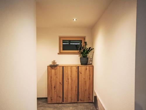 a wooden box in a hallway with a plant on it at Apartment Rosskopf by Interhome in Oberau