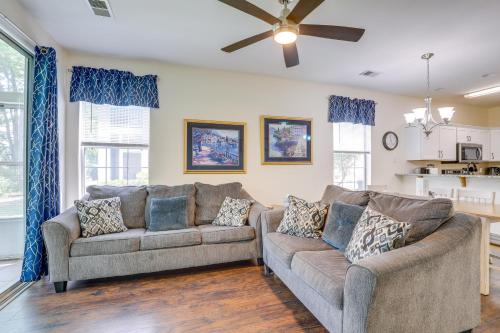 a living room with two couches and a ceiling fan at Ground-Floor Myrtle Beach Condo with Community Perks in Myrtle Beach