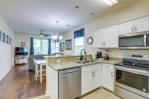 a kitchen with white cabinets and a counter top at Ground-Floor Myrtle Beach Condo with Community Perks in Myrtle Beach