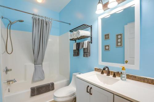 a bathroom with a sink and a toilet and a mirror at Ground-Floor Myrtle Beach Condo with Community Perks in Myrtle Beach