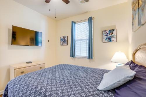a bedroom with a bed and a tv and a window at Ground-Floor Myrtle Beach Condo with Community Perks in Myrtle Beach